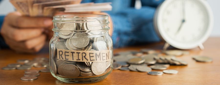man saving for retirement adding cash to a jar